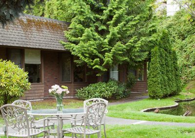 Courtyard with tables, trees, and a small pond at Ballard Center